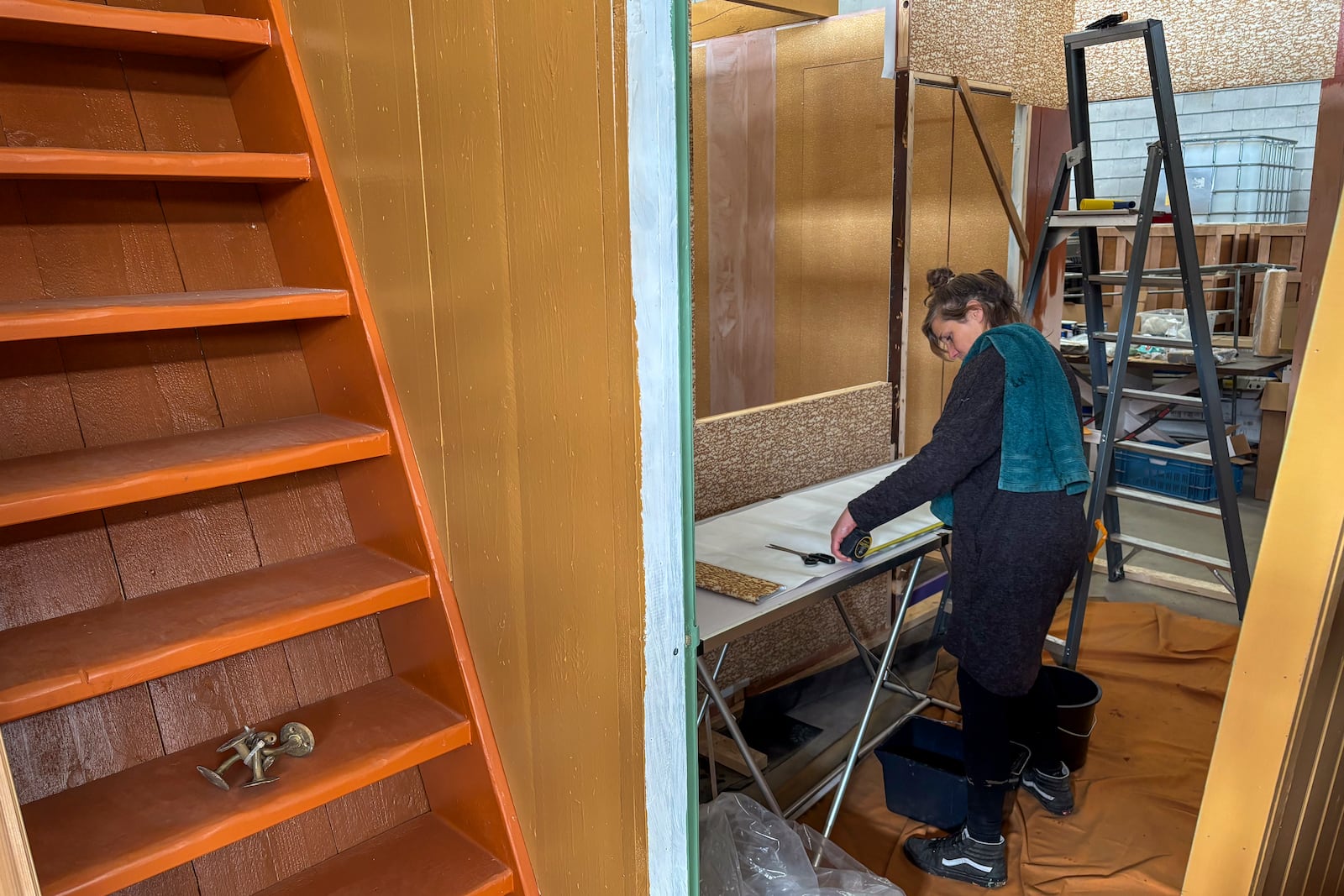 Wallpaper is being prepared for an exact replica of the secret annex which will travel to New York for an exhibit, in the village of Erp, southern Netherlands, Thursday, Oct. 10, 2024. (AP Photo/Aleksandar Furtula)