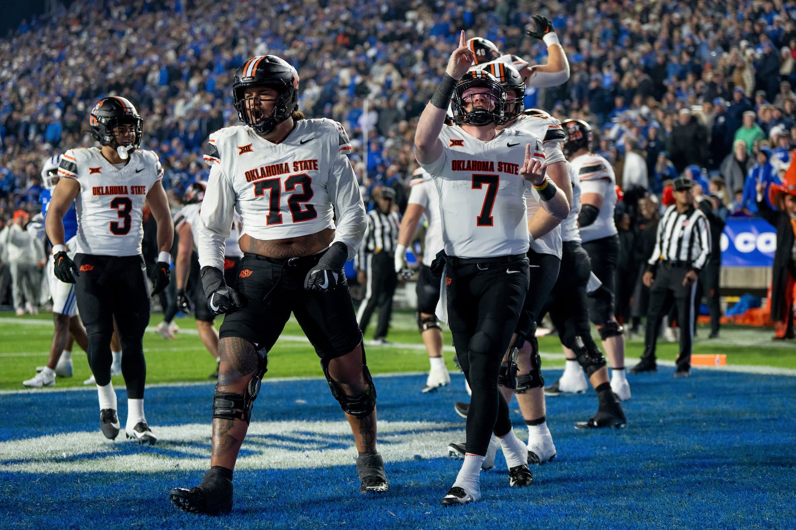 Oklahoma State offensive lineman Isaia Glass (72) and quarterback Alan Bowman (7) celebrate after a touchdown in the second half of an NCAA college football game against BYU, Friday, Oct. 18, 2024, in Provo, Utah. (AP Photo/Spenser Heaps)