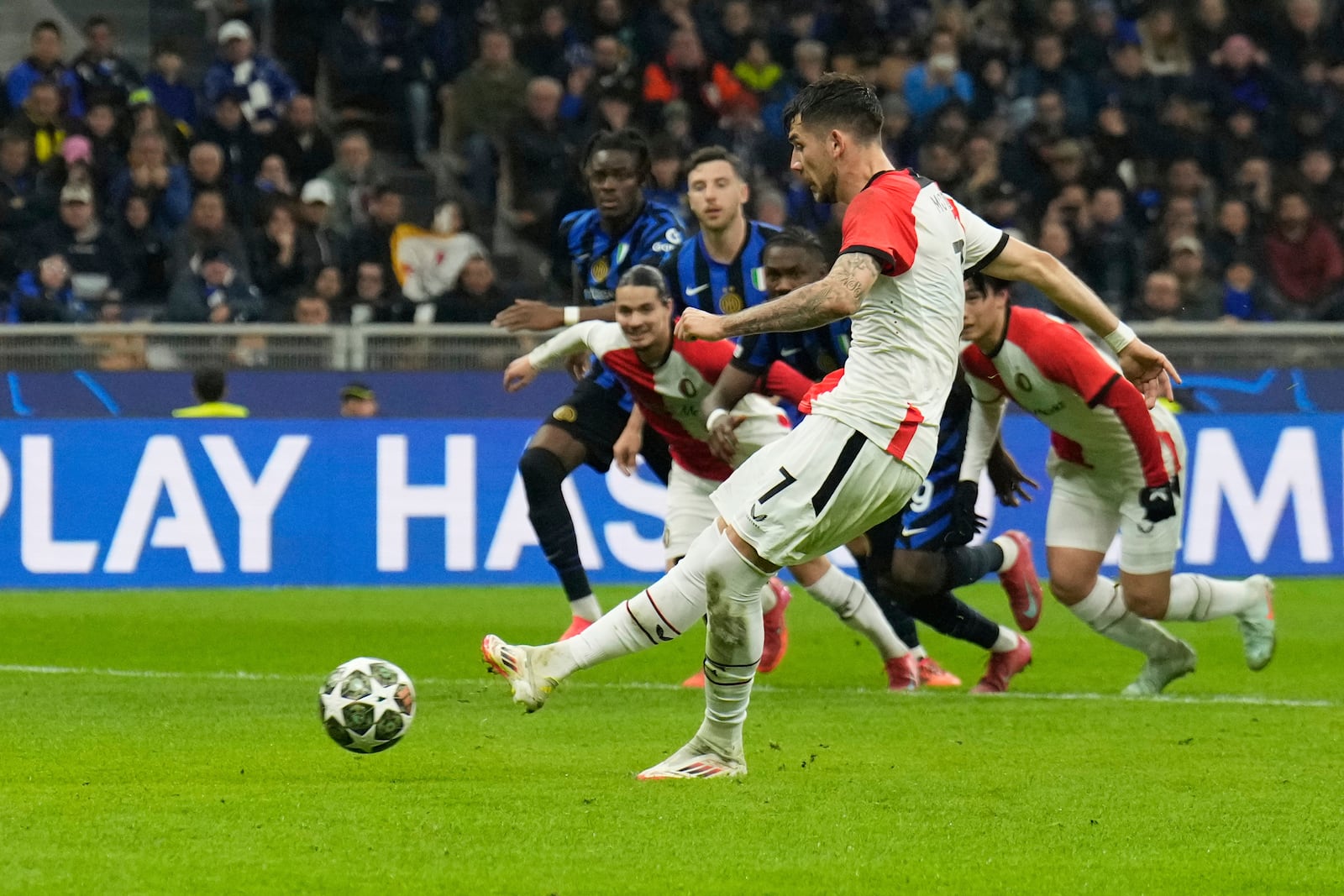 Feyenoord's Jakub Moder scores his side's opening goal during a Champions League round of 16 second leg soccer match between Inter Milan and Feyenoord, at the San Siro stadium in Milan, Italy, Tuesday, March 11, 2025. (AP Photo/Luca Bruno)