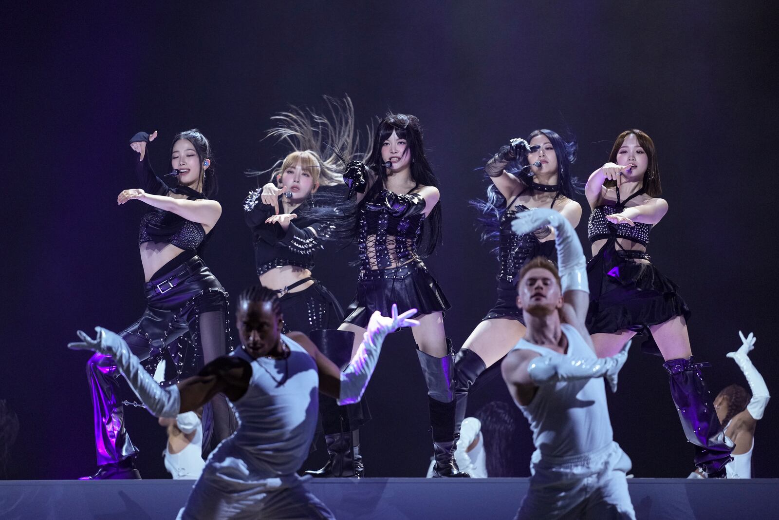 Kazuha, from left, Sakura Miyawaki, Hong Eunchae, Huh Yunjin, and Kim Chaewon, from the group 'Le Sserafim' perform during the MTV European Music Awards in Manchester, England, Sunday, Nov. 10, 2024. (Scott A Garfitt/Invision/AP)