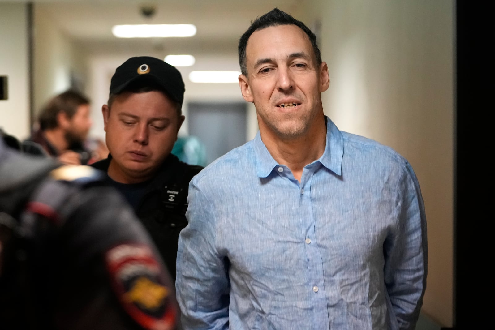 French citizen Laurent Vinatier is escorted to a court room at the Zamoskvoretsky District Court in Moscow, Russia, on Monday, Oct. 14, 2024. (AP Photo/Pavel Bednyakov)