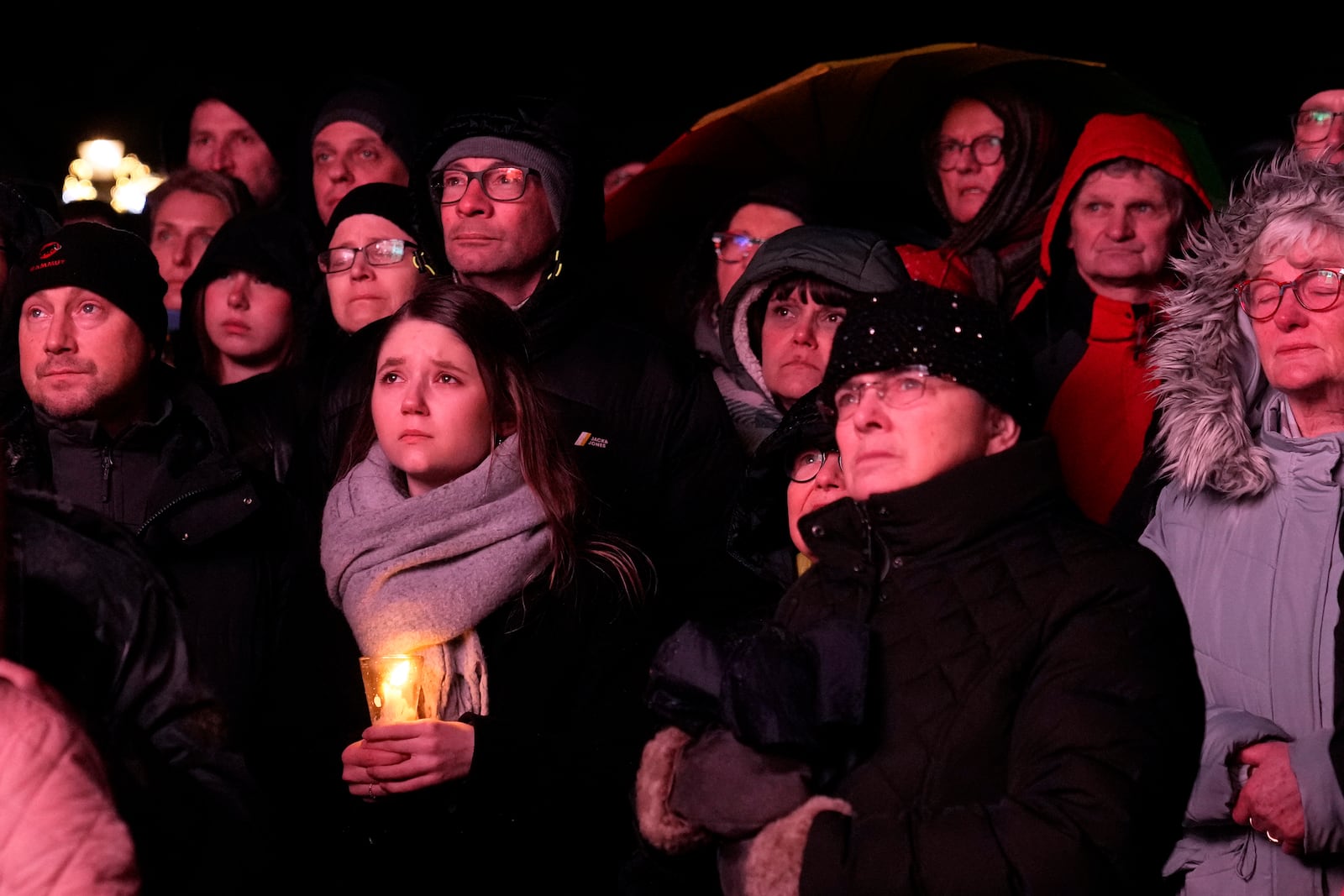 People outside Magdeburg Cathedral follow a memorial service for victims of Friday's Christmas Market attack, where a car drove into a crowd, in Magdeburg, Germany, Saturday, Dec. 21, 2024. (AP Photo/Ebrahim Noroozi)