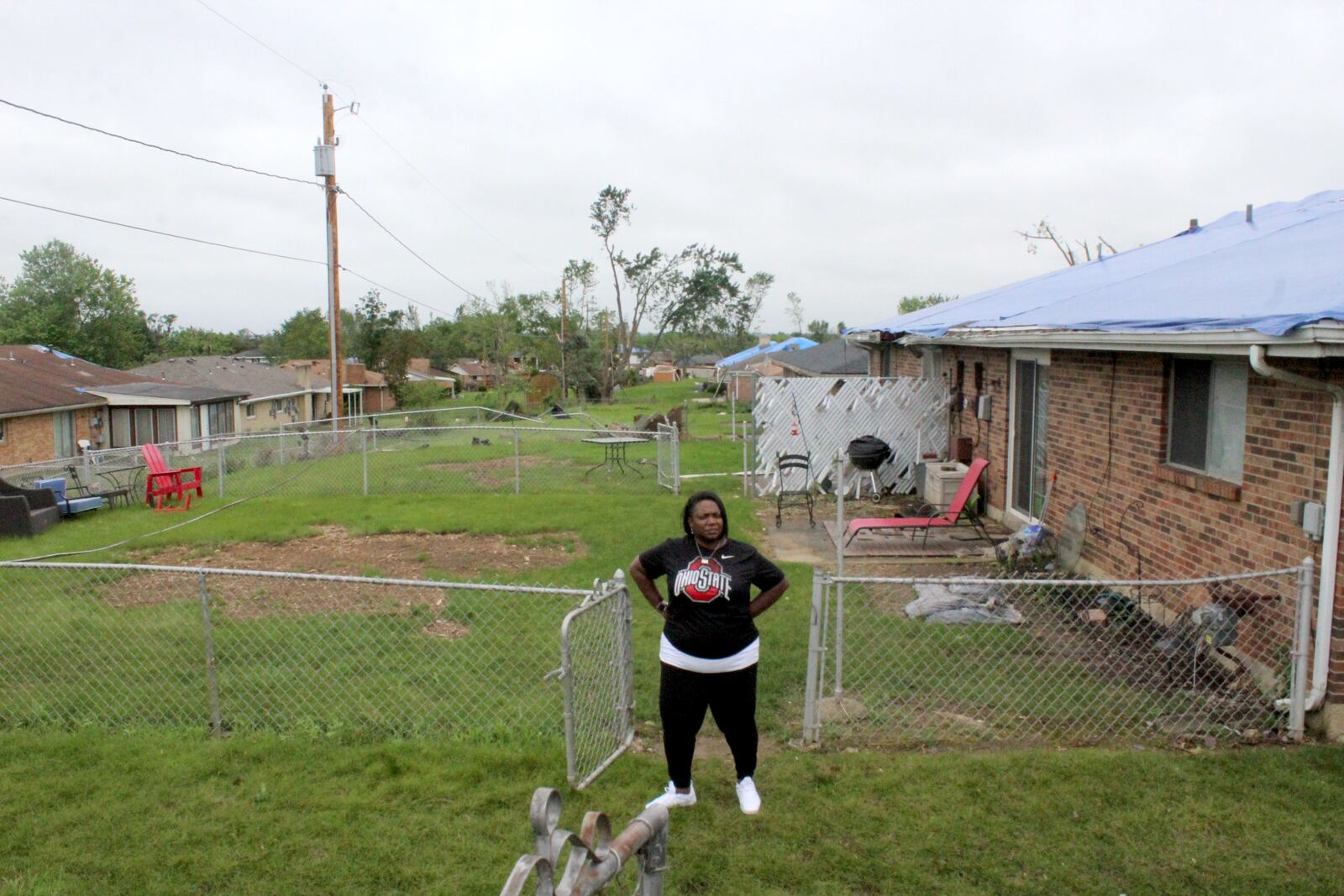 Kelly Watts in the back yard of her Trotwood home. The duplex was heavily damaged by one of 15 Memorial Day Tornadoes.