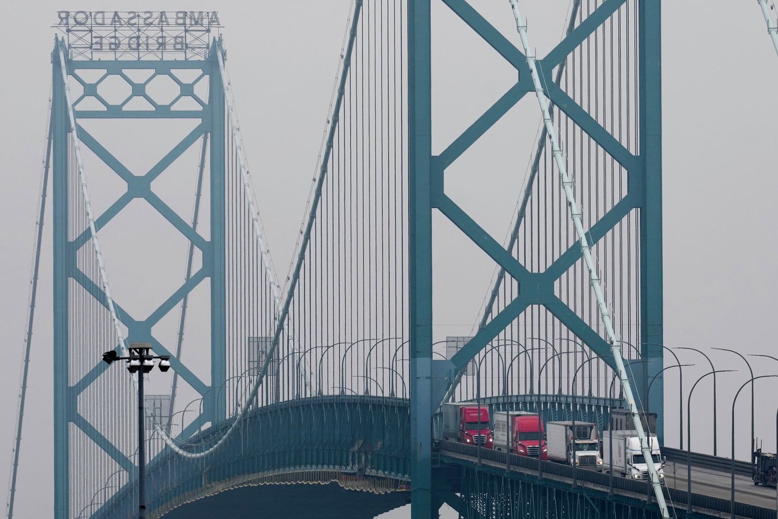 Trucks enter into the United States from Ontario, Canada across the Ambassador Bridge, Monday, Feb. 3, 2025, in Detroit. (AP Photo/Paul Sancya)