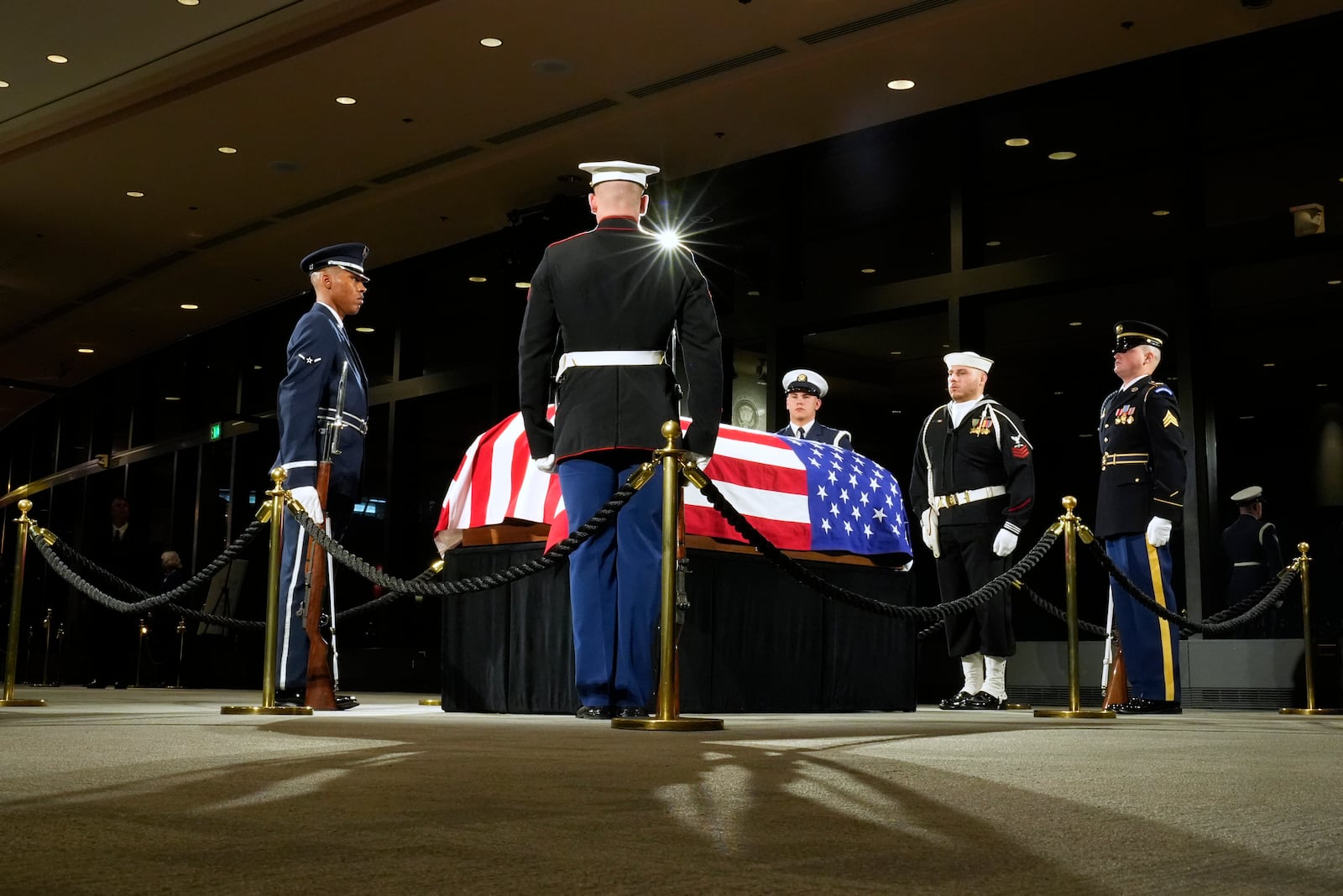 The Guard of Honor surrounds the flag-draped casket of former President Jimmy Carter as he lies in repose at the Jimmy Carter Presidential Library and Museum in Atlanta, Saturday, Jan. 4, 2025. Carter died Dec. 29 at the age of 100. (AP Photo/Alex Brandon, Pool)