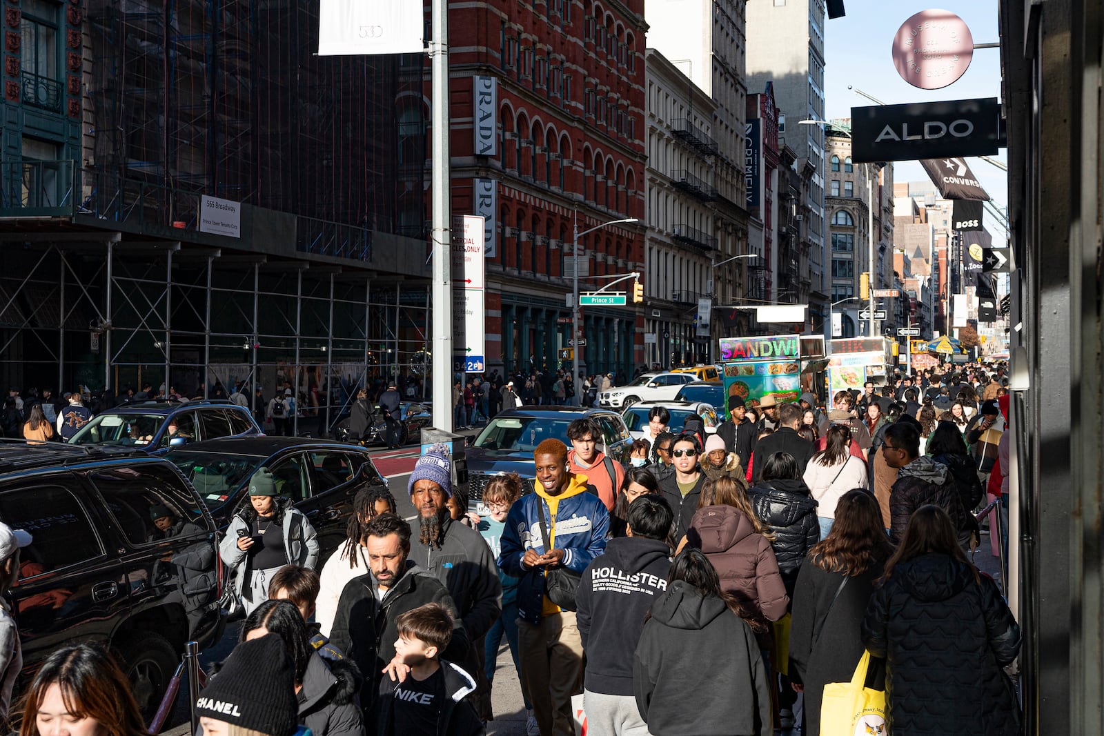 FILE - Shoppers and others walk down a crowded sidewalk on Black Friday in the Soho neighborhood of New York, Nov. 24, 2023. (AP Photo/Peter K. Afriyie, File)