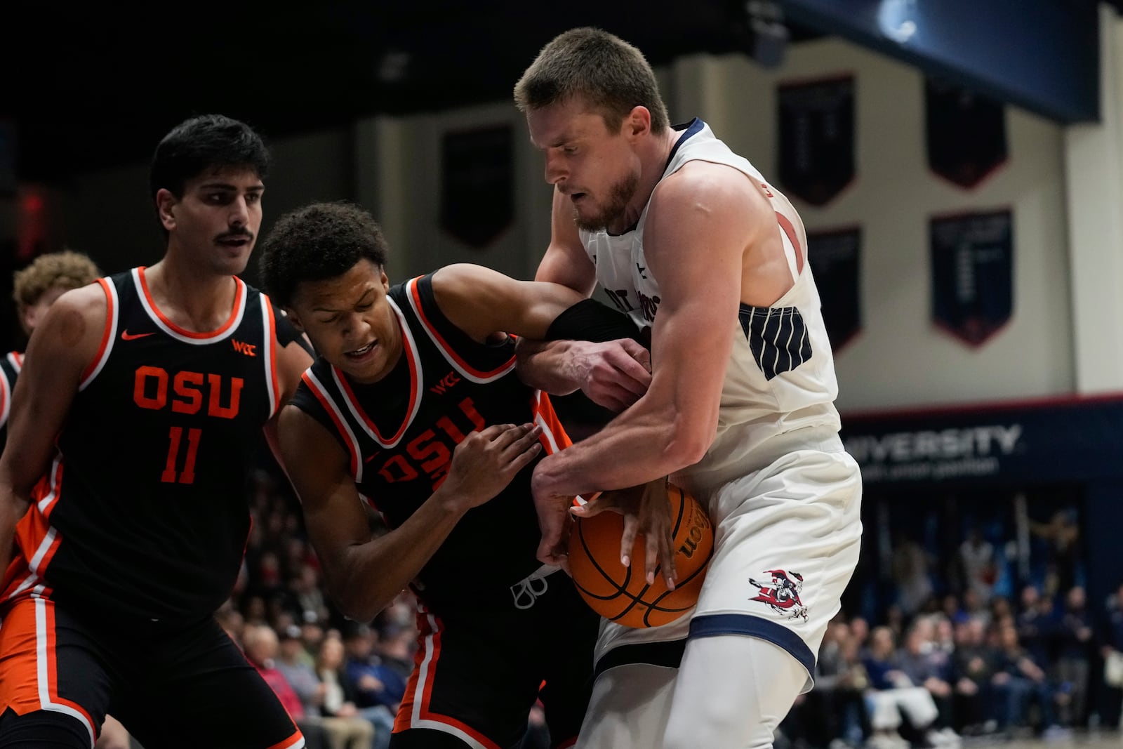 Oregon State guard Josiah Lake II, second from left, and Saint Mary's center Mitchell Saxen compete for possession of the ball during the first half of an NCAA college basketball game Saturday, March 1, 2025, in Moraga, Calif. (AP Photo/Godofredo A. Vásquez)