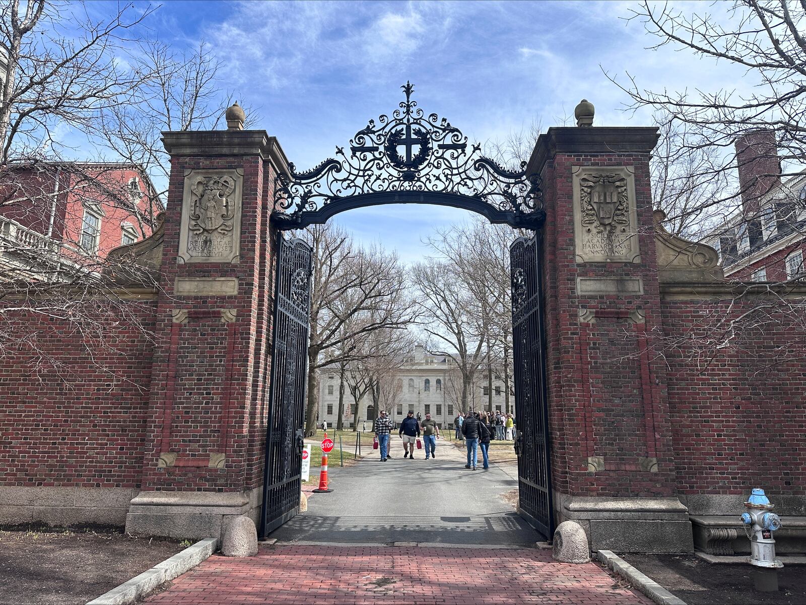 People walk through the campus of Harvard University in Cambridge, Mass., Tuesday, March 18, 2025, which announced plans to make tuition free for students of families making up to $200,00. (AP Photos/Michael Casey)