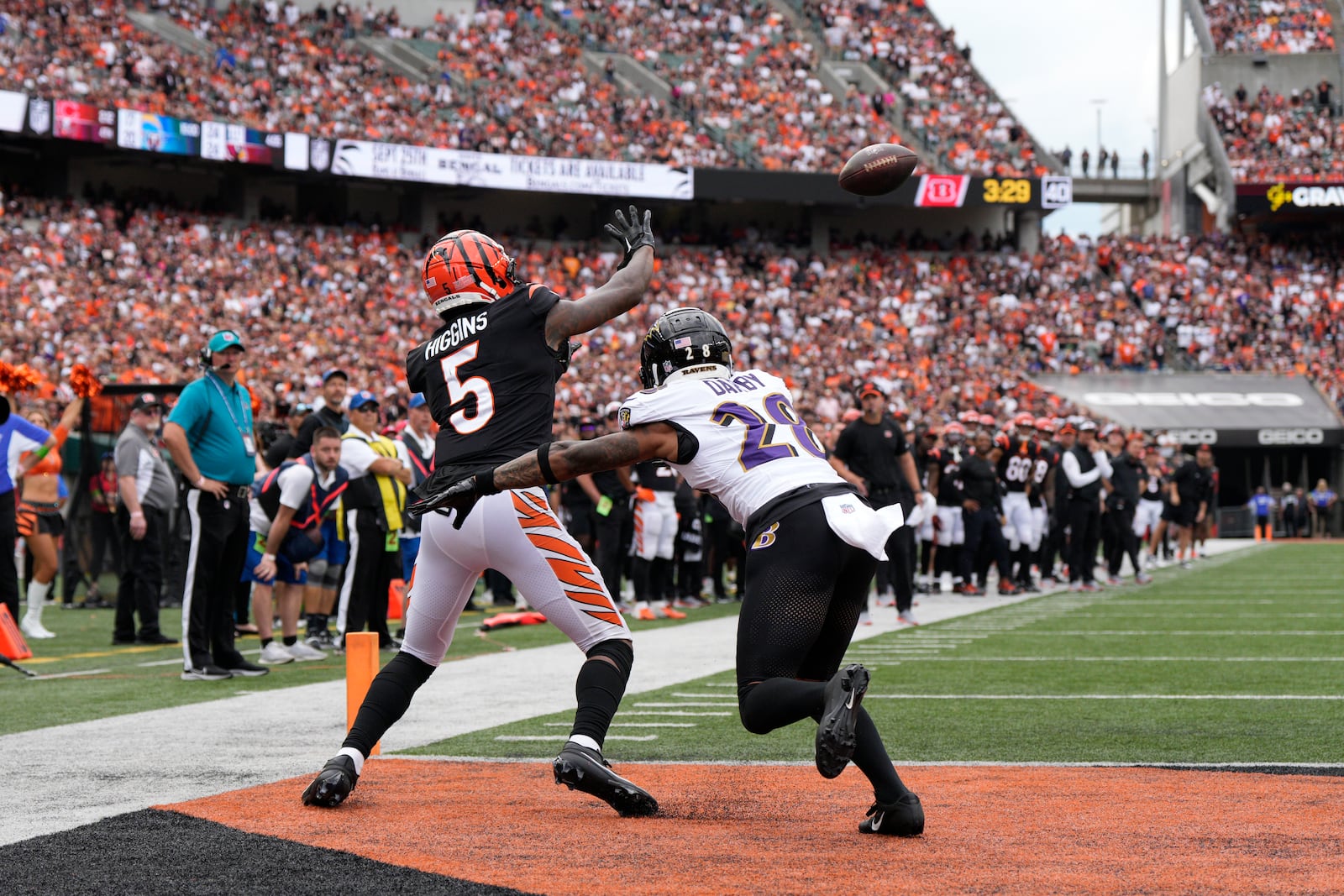 Cincinnati Bengals wide receiver Tee Higgins (5) catches a touchdown pass as Baltimore Ravens cornerback Ronald Darby (28) defends during the second half of an NFL football game Sunday, Sept. 17, 2023, in Cincinnati. (AP Photo/Jeff Dean)