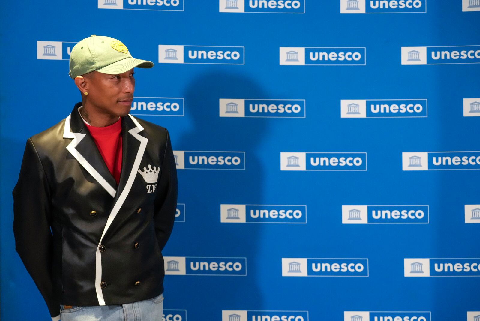 Pharrell Williams listening to UNESCO Director General Audrey Azoulay as he was named UNESCO Goodwill Ambassador for for Arts, Education and Entrepreneurship at UNESCO headquarters in Paris, Tuesday, Dec. 17, 2024. (AP Photo/Michel Euler)