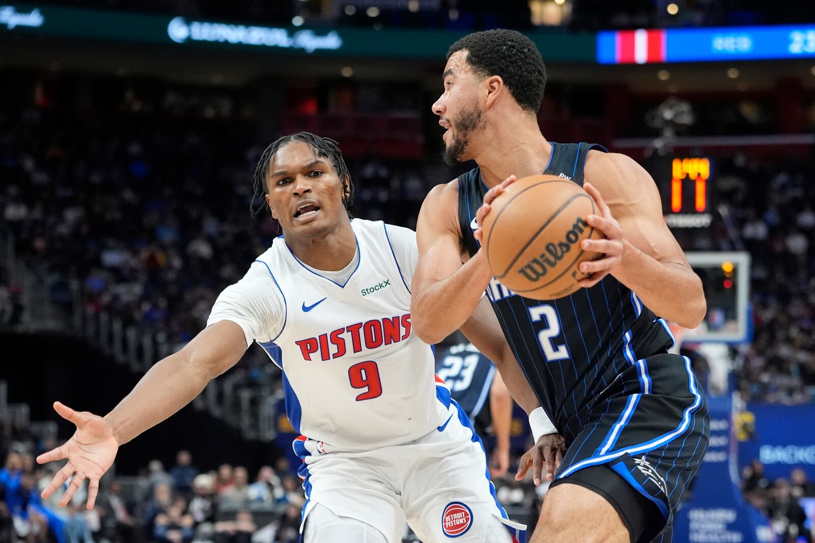 Orlando Magic guard Caleb Houstan (2) looks to pass as Detroit Pistons forward Ausar Thompson (9) defends during the first half of an NBA basketball game, Wednesday, Jan. 1, 2025, in Detroit. (AP Photo/Carlos Osorio)