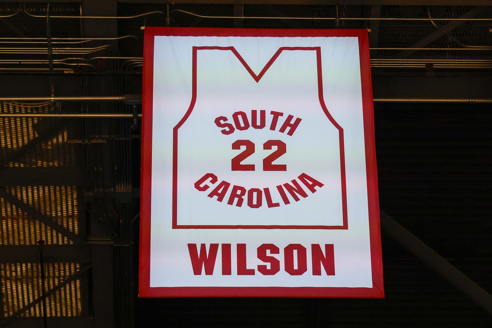 A'ja Wilson, center, stands with her parents Eva and Roscoe Wilson as they watch her number be retired during a ceremony before an NCAA college basketball game between South Carolina and Auburn in Columbia, S.C., Sunday, Feb. 2, 2025. (AP Photo/Nell Redmond)