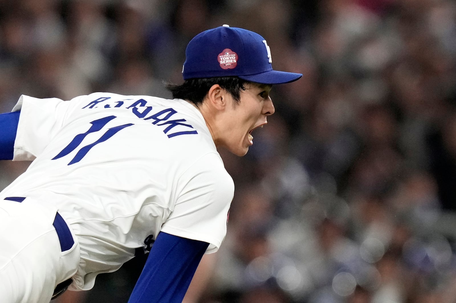 Los Angeles Dodgers' Roki Sasaki follows through on his delivery to the Chicago Cubs in the first inning of an MLB Tokyo Series baseball game in Tokyo, Japan, Wednesday, March 19, 2025. (AP Photo/Eugene Hoshiko)