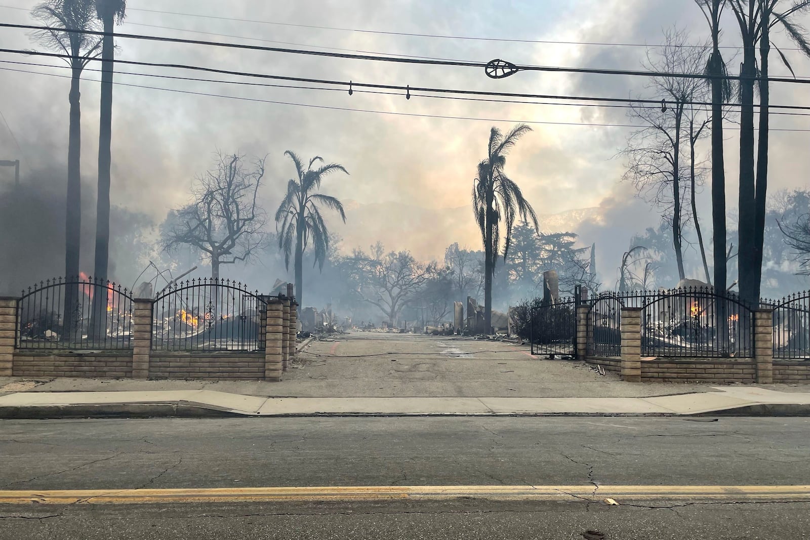 This photo provided by EJ Soto shows the destroyed entrance to the housing development from which her family was forced to evacuate due to wildfire, Wednesday, Jan. 8, 2024, in Altadena, Cali. (EJ Soto via AP)