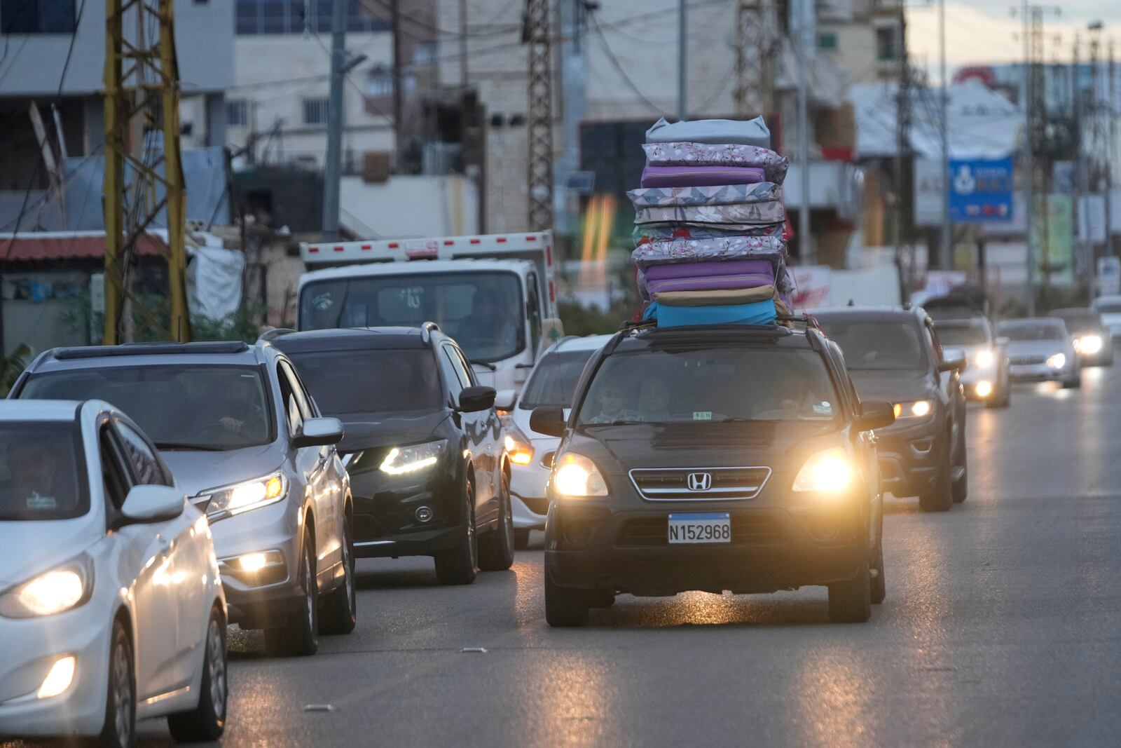 People in their cars return back to their villages after the ceasefire between Hezbollah and Israel began early morning, in Tyre, south Lebanon, Wednesday, Nov. 27, 2024. (AP Photo/Hussein Malla)