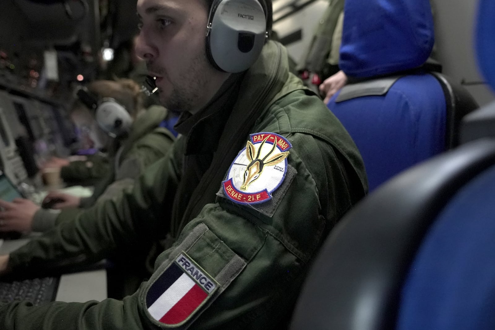 Crew members aboard a French Navy Atlantique 2 surveillance plane watch the onboard monitors showing data and images from the aircraft's radars, cameras and other sensors as it patrols Thursday, Jan. 23, 2025, over the Baltic Sea as part of the NATO military alliance's "Baltic Sentry" mission to protect undersea cables and pipelines from sabotage. (AP Photo/John Leicester)