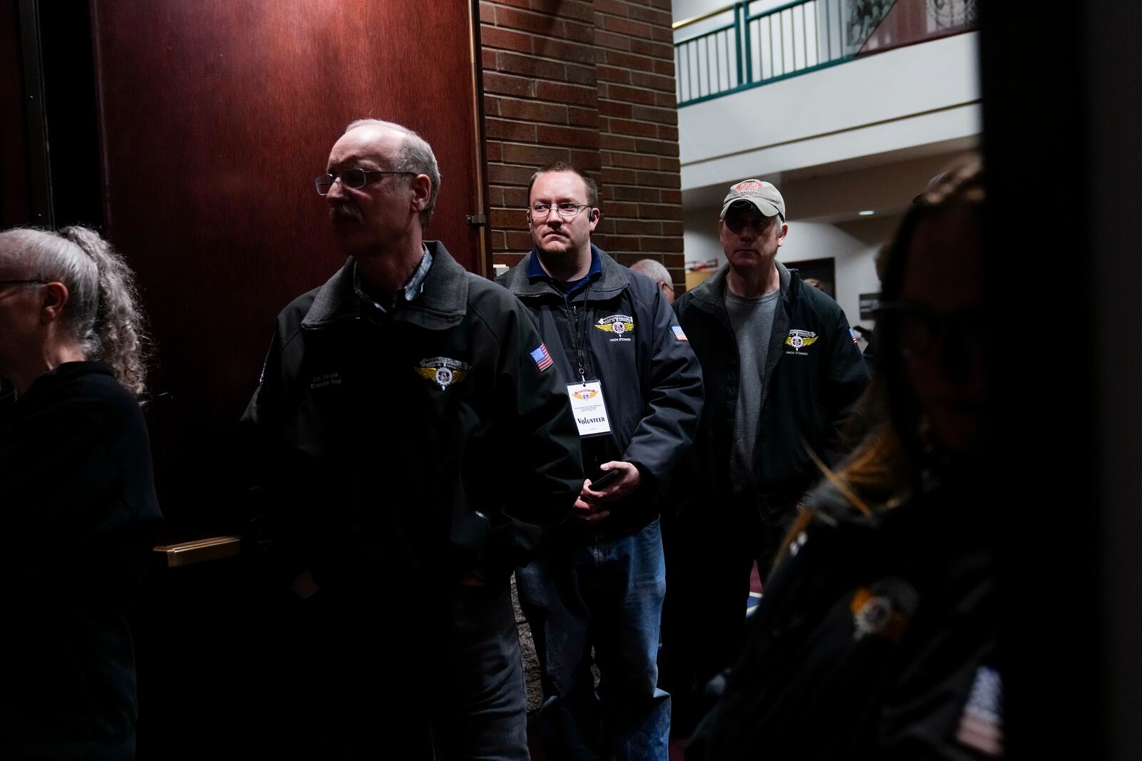 Workers listen as IAM District 751 president Jon Holden gives a press conference after announcing the union voted to accept a new contract offer from Boeing, Monday, Nov. 4, 2024, at their union hall in Seattle. (AP Photo/Lindsey Wasson)