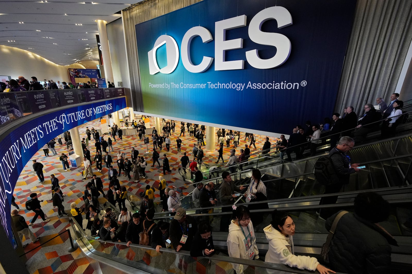 People attend the CES tech show Wednesday, Jan. 8, 2025, in Las Vegas. (AP Photo/John Locher)