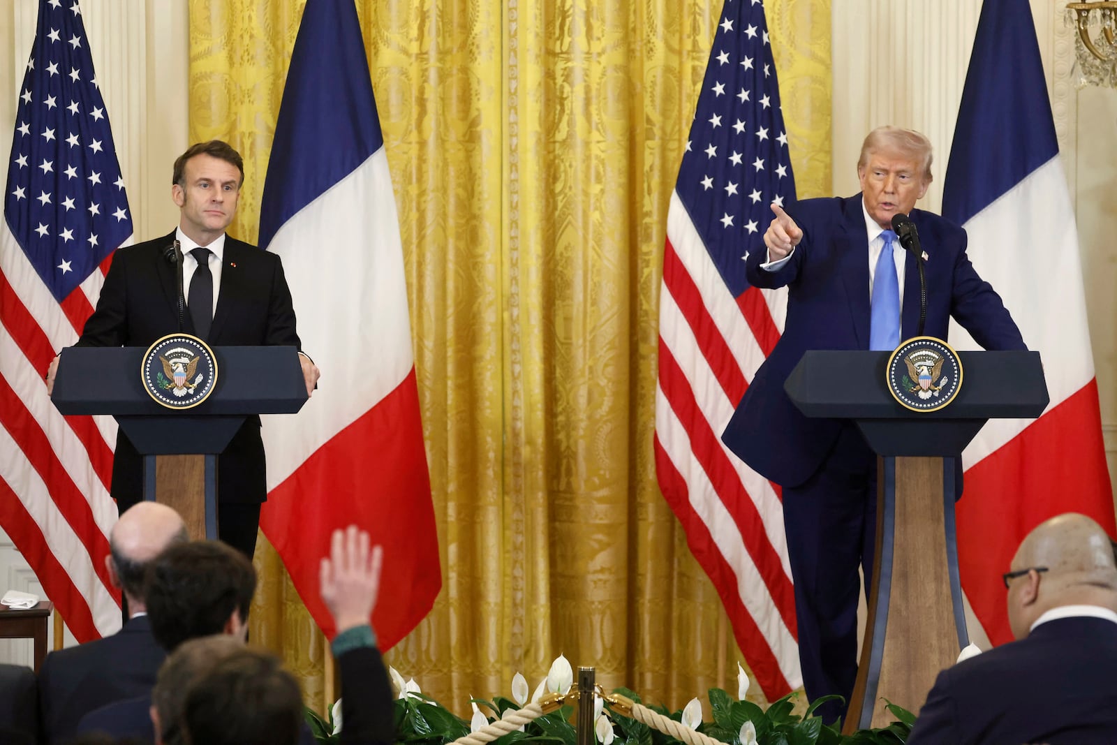 President Donald Trump speaks as France's President Emmanuel Macron listens during a joint press conference in the East Room of the White House in Washington, Monday, Feb. 24, 2025. (Ludovic Marin/Pool via AP)