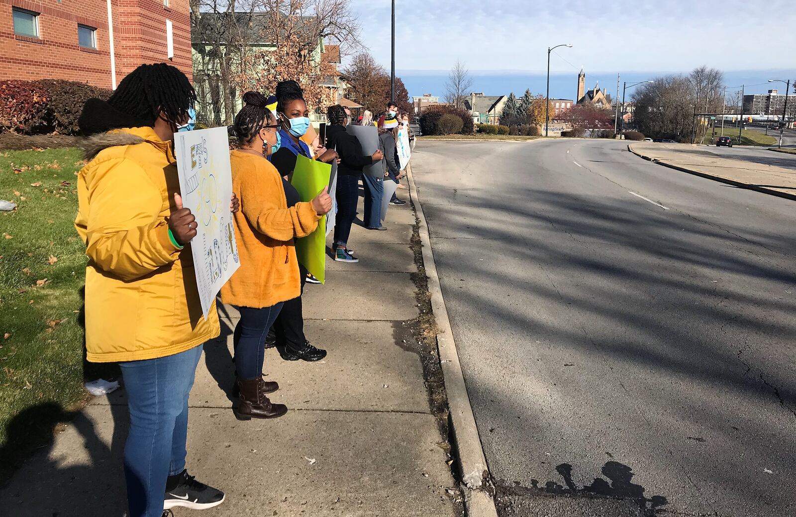 People gather outside of Rocking Horse Community Health Center Friday morning to show support to Springfield Highschool Football players heading to the state championship game. HASAN KARIM/STAFF