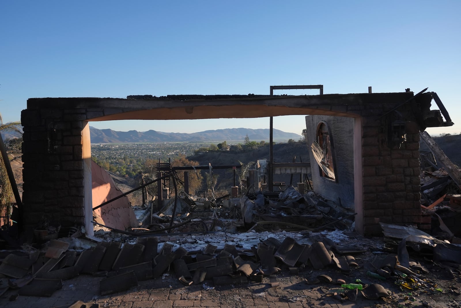 The remains of a home destroyed by the Mountain Fire is shown in Camarillo, Calif., Friday, Nov. 8, 2024. (AP Photo/Jae C. Hong)