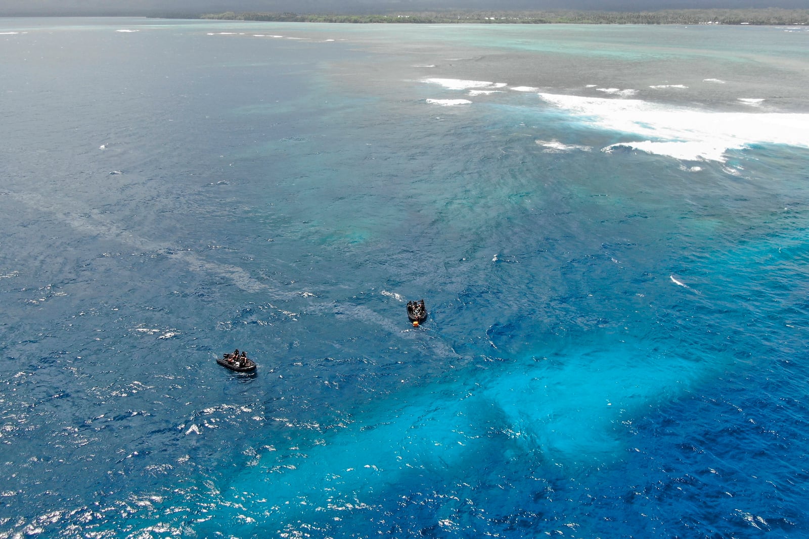 In this photo provided by the New Zealand Defence Force, divers survey the area around HMNZS Manawanui on the southern coast of Upulo, Samoa, after the Manawanui ran aground and sank on Oct. 6. (SGT Vanessa Parker/New Zealand Defence Force via AP)