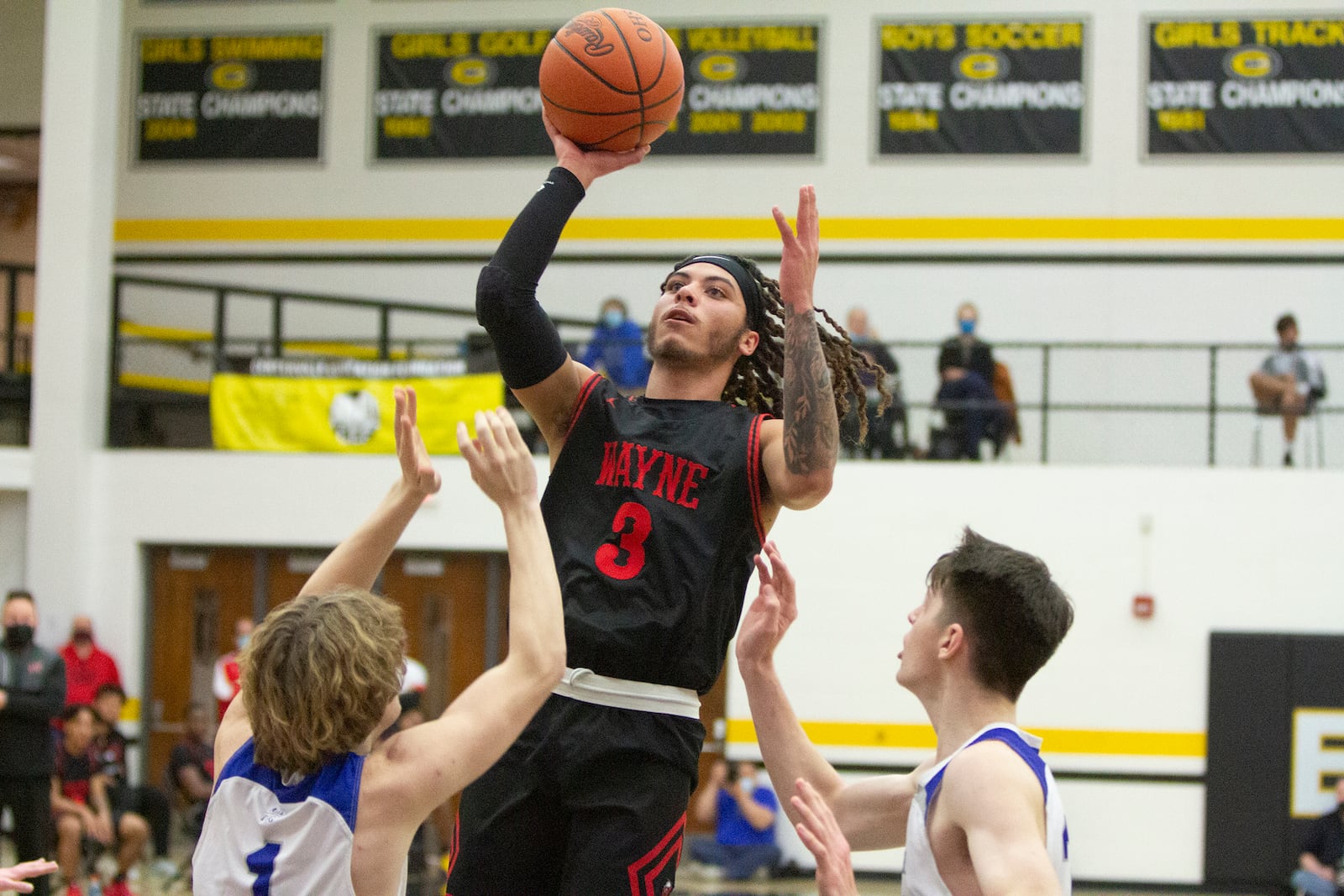 Wayne senior Malcolm Curry shoots over Cincinnati St. Xavier's Jonny Vanover during Saturday night's Division I district final at Centerville High School. Curry scored 13 points in the Warriors' 81-65 loss. Jeff Gilbert/CONTRIBUTED