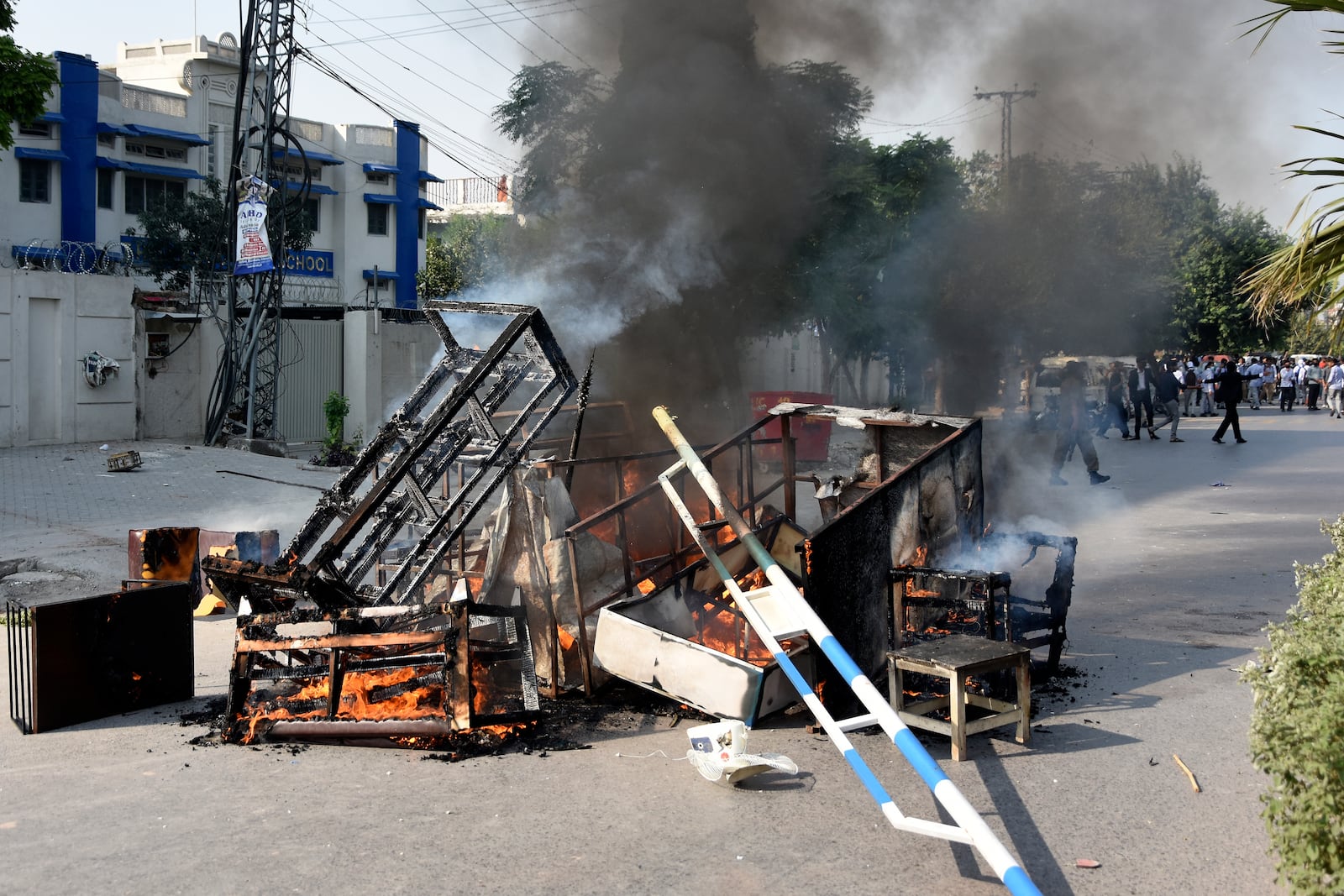 Smoke erupts from burning furniture and other material, set on fire by angry students protesting over an alleged on-campus rape in Punjab, in Rawalpindi, Pakistan, Thursday, Oct. 17, 2024. (AP Photo/W.K. Yousafzai)