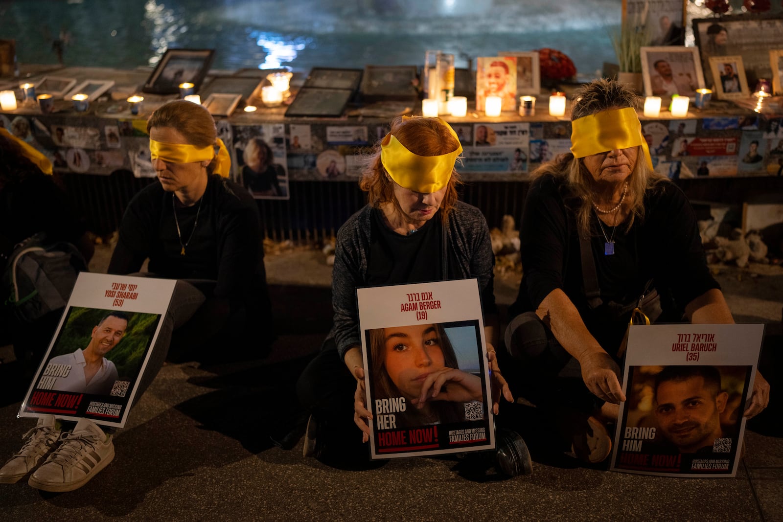 FILE - Activists sit blindfolded to mark one year in the Hebrew calendar since the Hamas cross-border attack on Israel in a protest against the celebration of the Jewish holiday of Simchat Torah while hostages are still held in Gaza, in Tel Aviv, Israel, Thursday, Oct. 24, 2024. (AP Photo/Oded Balilty, File)