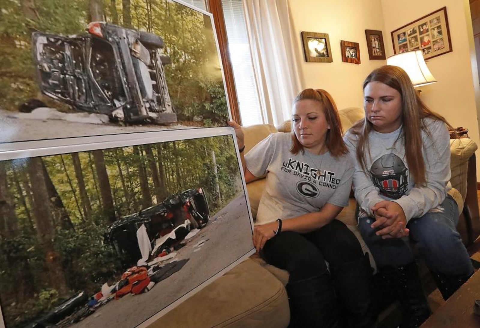 Aryn Waag, left, the mother of David Waag, and Devin Williams, the sister of Connor Williams, look over the enlarged pictures of the crash that claimed the lives of David and Connor 2017. Bill Lackey/Staff