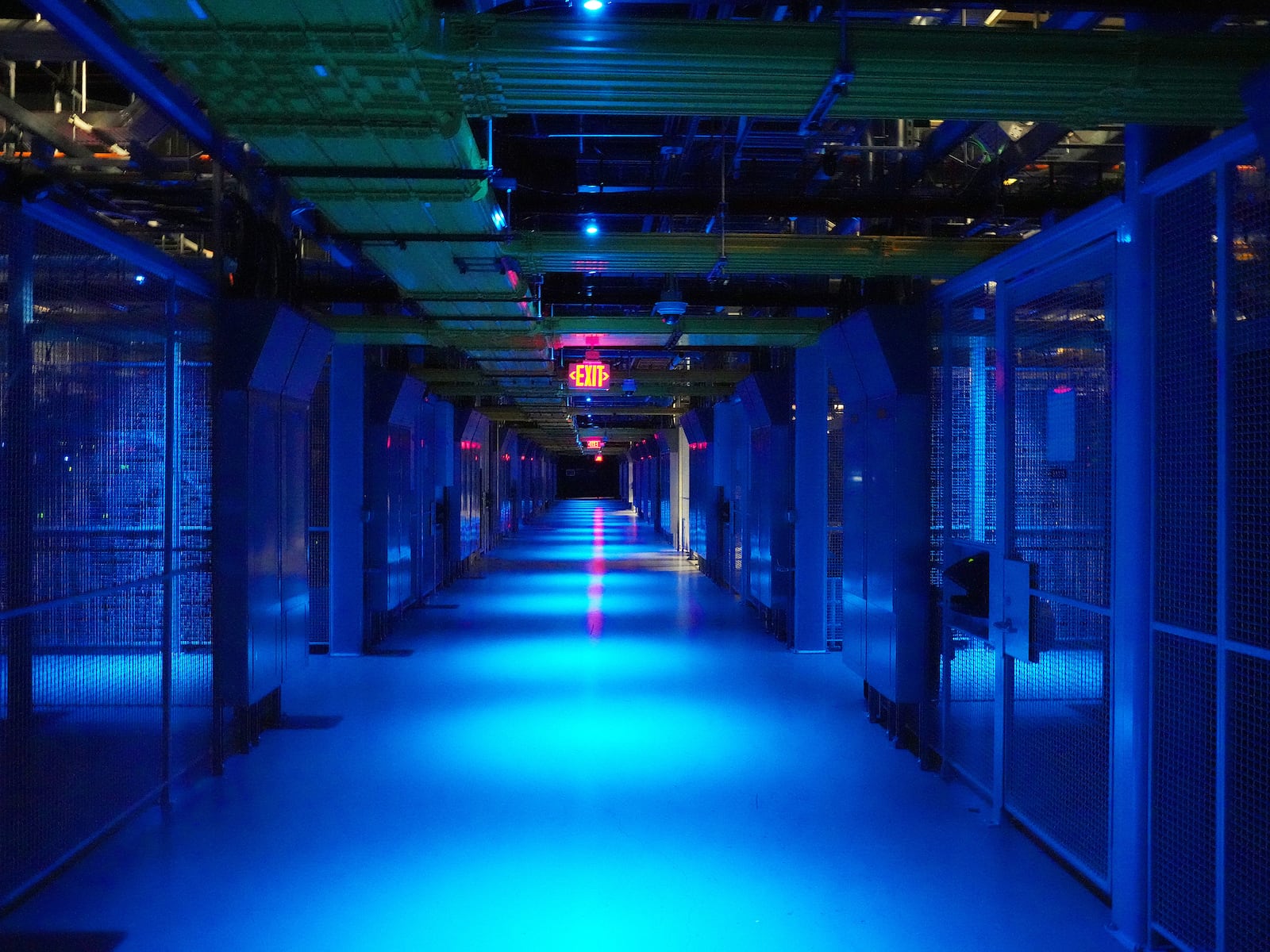 
                        FILE — Blue lights illuminate an aisle at a data center in San Jose, Calif., Feb. 23, 2024. Bernard Looney, the former chief executive of BP, one of the world’s largest energy companies, said Sunday, Nov. 24, that he would become chairman of a data center start-up in the United States, a move that comes amid a ravenous appetite for electricity to power the boom in artificial intelligence. (Jim Wilson/The New York Times)
                      