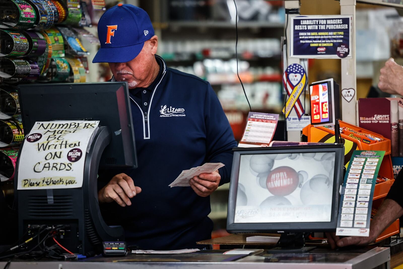 Vinny's Bar & Grill Carry-out Lottery assistant manager, Jim Koehnen counts lottery tickets at the store Friday May 26, 2023. JIM NOELKER/STAFF