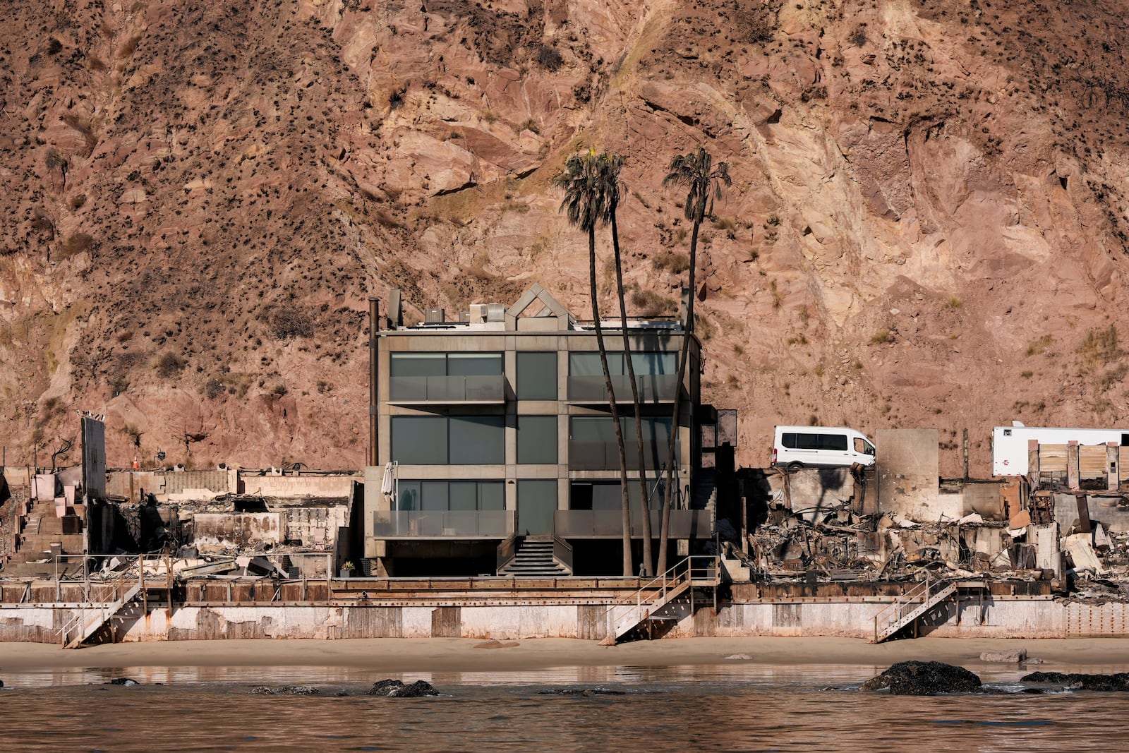 FILE - Damage to beachfront homes by the Palisades Fire is visible along the coastline, Jan. 15, 2025, in Malibu, Calif. (AP Photo/Carolyn Kaster, File)