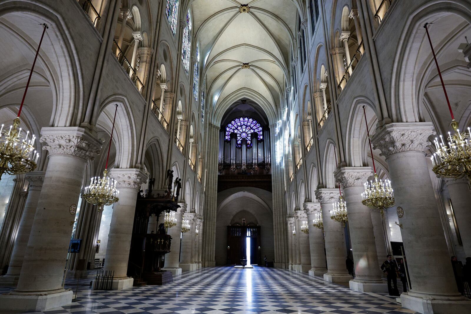 The nave, the western Rose stainless window and the organ of Notre-Dame de Paris cathedral are seen while French President Emmanuel Macron visits the restored interiors of the monument, Friday Nov. 29, 2024, in Paris. (Stephane de Sakutin, Pool via AP)