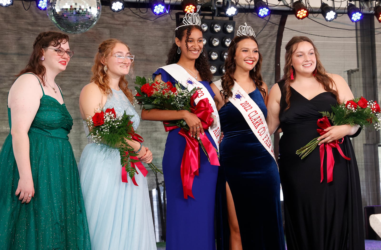 Chloe Gillaugh, the 2023 Clark County Fair Queen, is surrounded by Rebekah Hardacre, the 2022 Queen, and fellow contestants, from left, Katherine Sprowl, Brooke Comer and Megan Thatcher. BILL LACKEY/STAFF