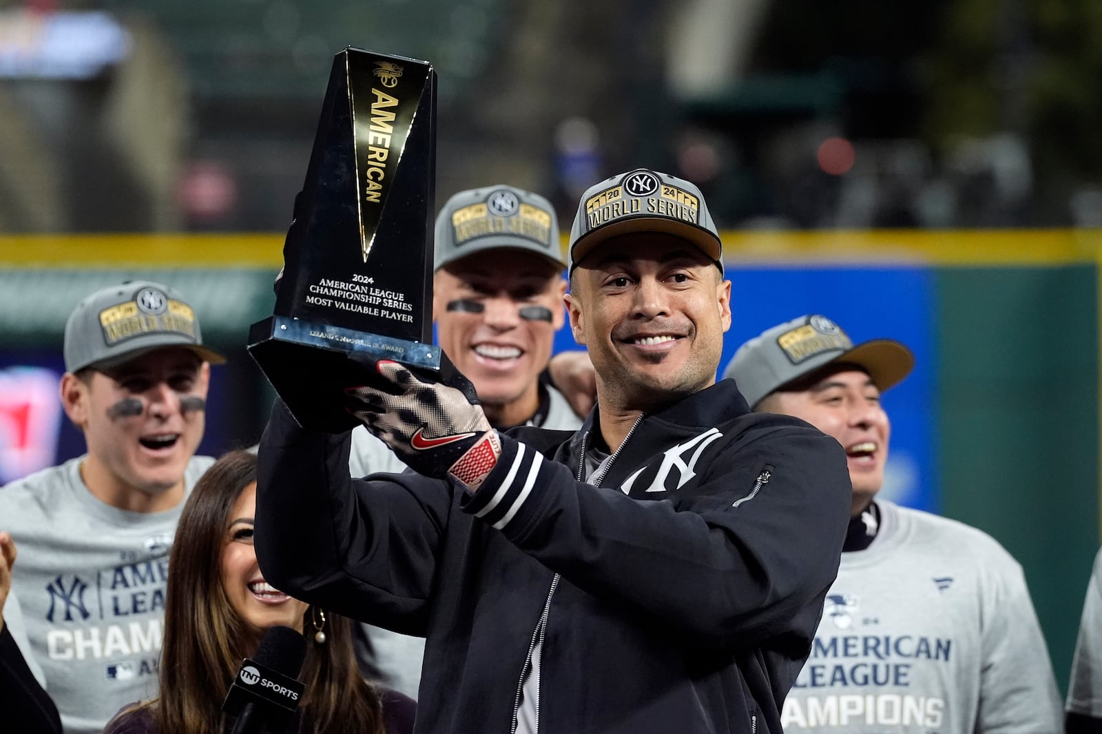 New York Yankees' Giancarlo Stanton holds up the MVP trophy after Game 5 of the baseball AL Championship Series Sunday, Oct. 20, 2024, in Cleveland. The Yankees won 5-2 to advance to the World Series. (AP Photo/Godofredo A. Vásquez )