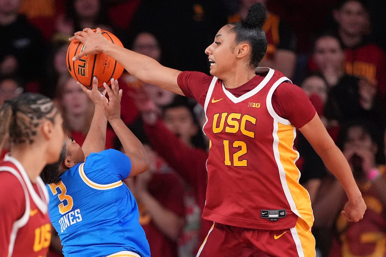 Southern California guard JuJu Watkins, right, blocks the shot of UCLA guard Londynn Jones during the second half of an NCAA college basketball game, Thursday, Feb. 13, 2025, in Los Angeles. (AP Photo/Mark J. Terrill)