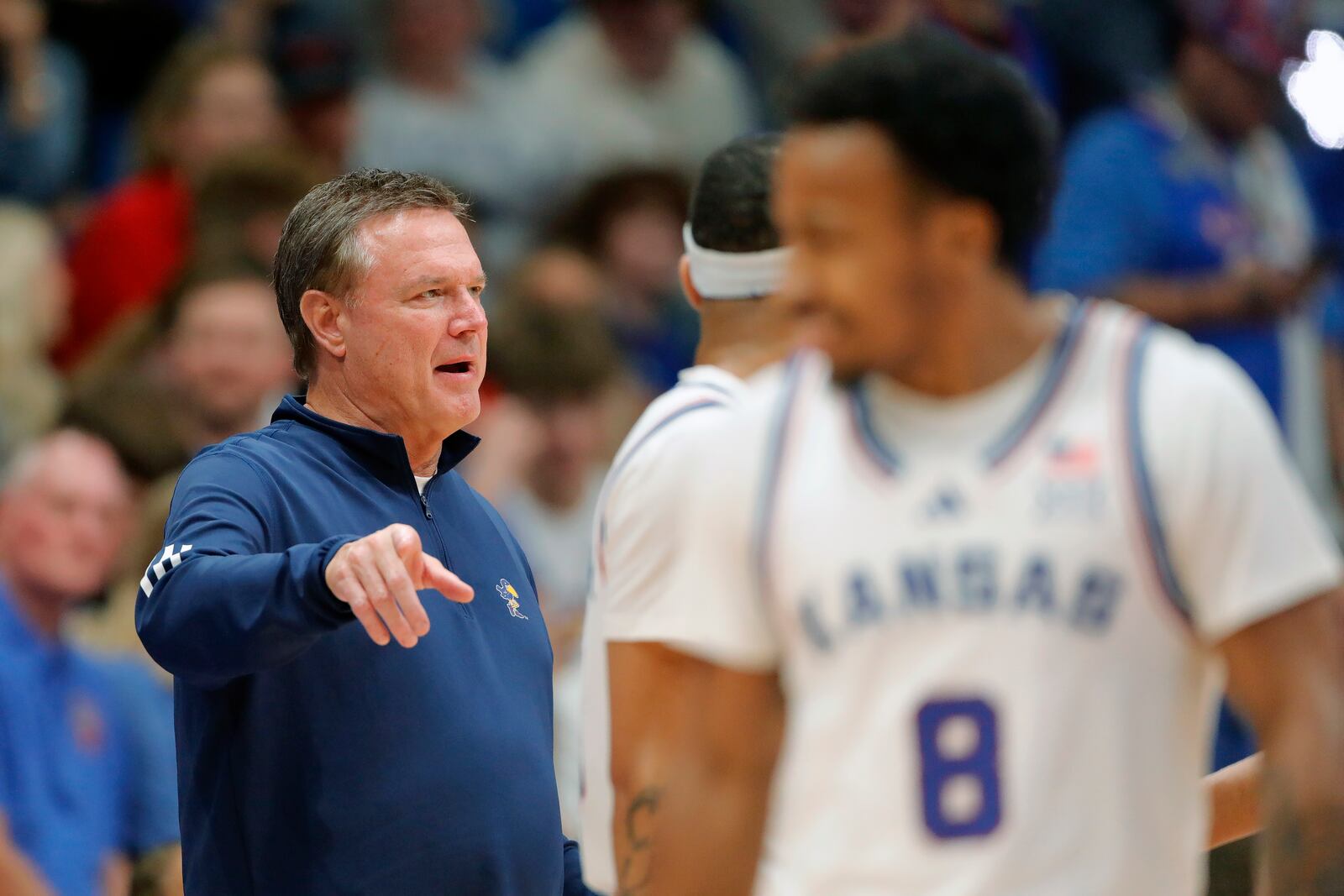 Kansas head coach Bill Self, left, speaks with his players during the second half of an NCAA college basketball game against Howard, Monday, Nov. 4, 2024, in Lawrence, Kan. (AP Photo/Colin E. Braley)