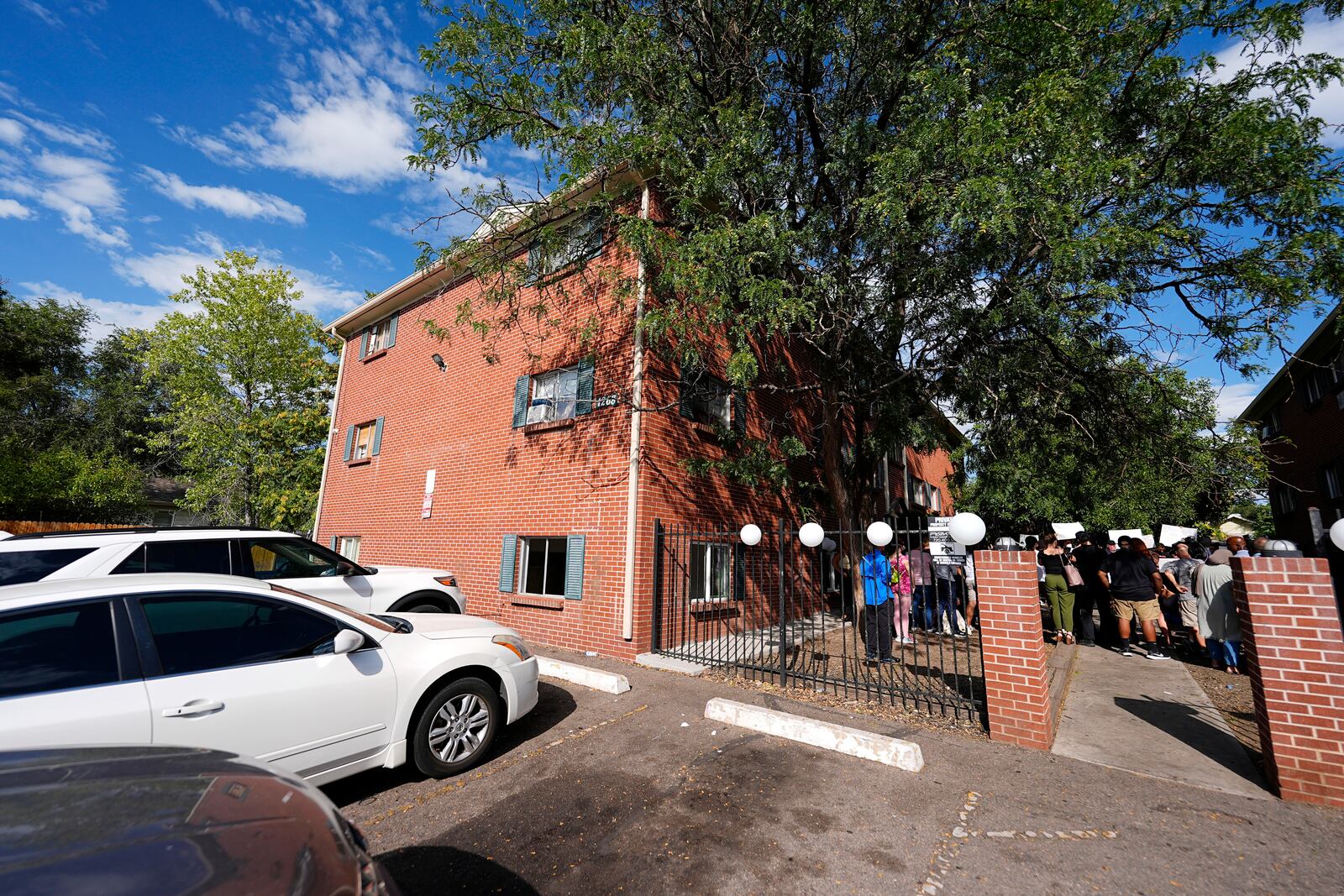 FILE - A rally in the courtyard is staged by the East Colfax Community Collective to address chronic problems in the apartment buildings occupied by people displaced from their home countries in central and South America Tuesday, Sept. 3, 2024, in Aurora, Colo. (AP Photo/David Zalubowski, File)