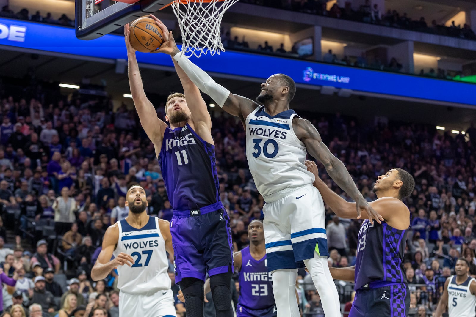 Sacramento Kings forward Domantas Sabonis (11) battles for a rebound with Minnesota Timberwolves forward Julius Randle (30) during overtime of an Emirates NBA Cup basketball game Friday, Nov. 15, 2024, in Sacramento, Calif. (AP Photo/Sara Nevis)