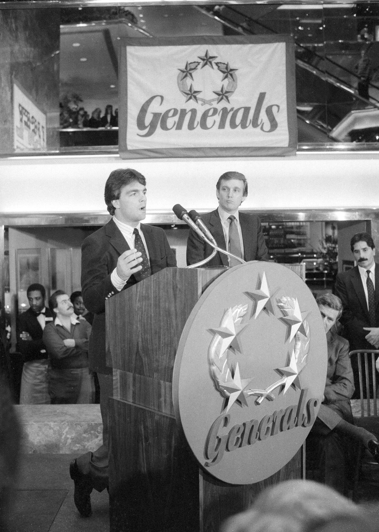 FILE - Doug Flutie, the New Jersey Generals newly-signed quarterback, talks to reporters during a news conference in New York, Feb. 6, 1985, after he was signed by the team's owner, Donald Trump, right, for four years at approximately $7 million. (AP Photo/Marty Lederhandler, File)