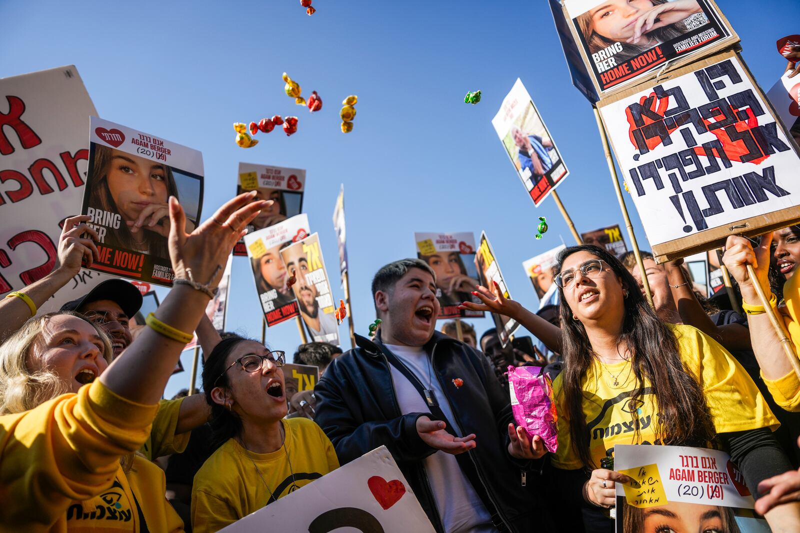 People react as they watch broadcast of the release of Israeli soldier Agam Berger, one of eight hostages set to be released today as part of a ceasefire in the Gaza Strip, in Tel Aviv, Israel, Thursday, Jan. 30, 2025. (AP Photo/Oded Balilty)