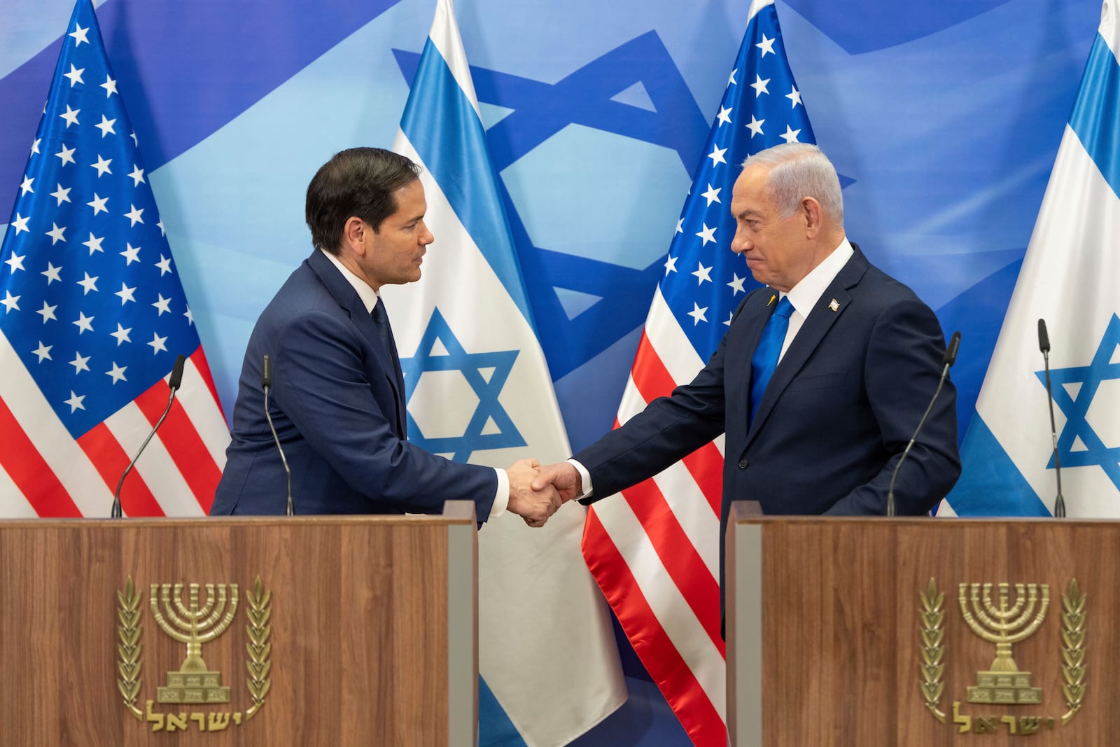 U.S. Secretary of State Marco Rubio, left, and Israeli Prime Minister Benjamin Netanyahu shake hands during a news conference at the Prime Minister's office in Jerusalem, Israel, Sunday, Feb. 16, 2025. (AP Photo/Ohad Zwigenberg,Pool)