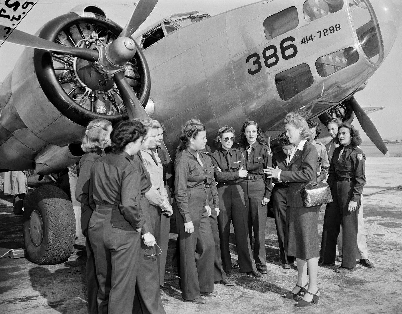 FILE - Jacqueline Cochran, Director of Women Pilots for the Army Air Forces, talks to members of the Women Airforce Service Pilots before an AT10 plane at Camp Davis, N.C., Oct. 24, 1943. These WASPS serve as an auxiliary unit working with the U.S. air and ground forces. (AP Photo, File)