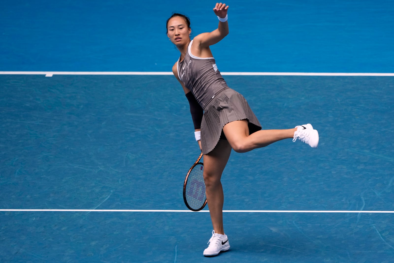 Zheng Qinwen of China reacts during her second round match against Laura Siegemund of Germany at the Australian Open tennis championship in Melbourne, Australia, Wednesday, Jan. 15, 2025. (AP Photo/Asanka Brendon Ratnayake)