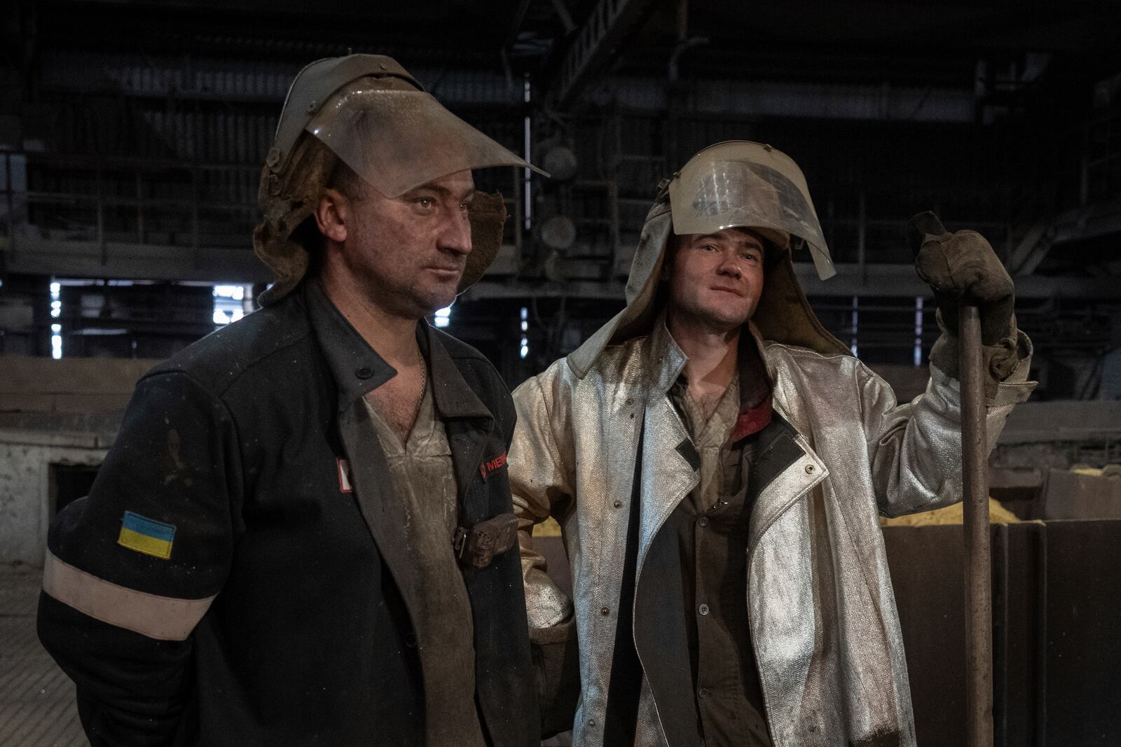 Steel melting workers chat at work at the Zaporizhstal Iron and Steelworks, one of the country's largest steel plants, in Zaporizhzhia, Ukraine, Thursday, Feb. 13, 2025. (AP Photo/Efrem Lukatsky)