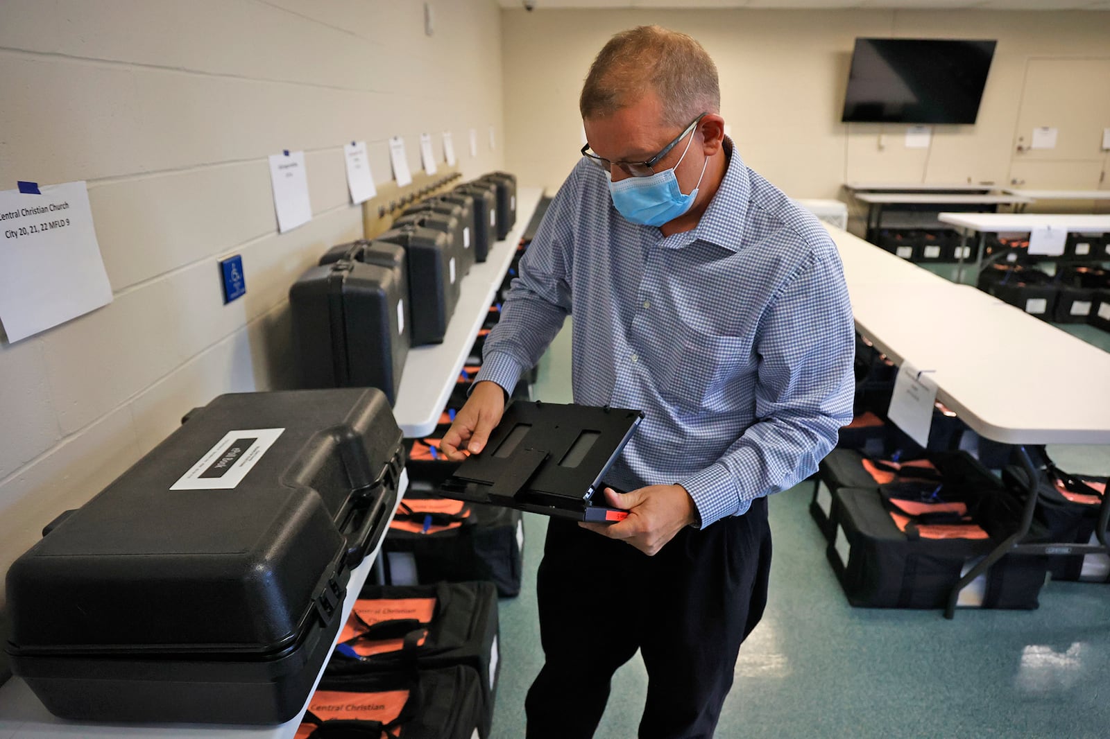 Jason Baker, director of the Clark County Board of Elections, opens up one of the ePoll Books as he demonstrates how they work Monday, Nov. 7, 2022 at the Board of Elections office. BILL LACKEY/STAFF