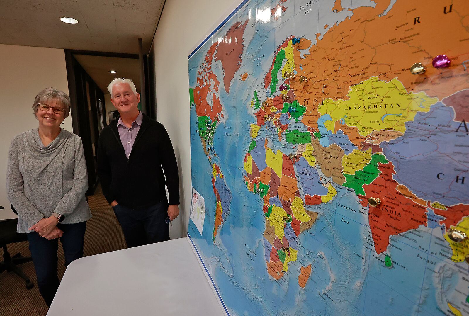 Ellen Dudney and Grant Edwards, from Discipling Another, with a map showing all the places the group operates around the world. BILL LACKEY/STAFF