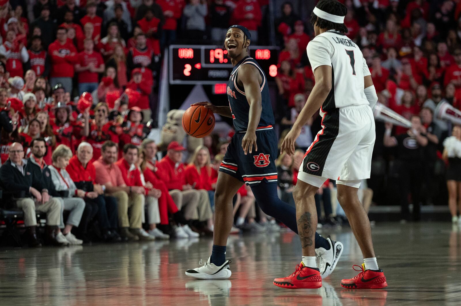 Auburn guard Denver Jones (2) yells to teammates while dribbling the ball past Georgia guard Tyrin Lawrence (7) during the first half of an NCAA college basketball game, Saturday, Jan. 18, 2025, in Athens, Ga. (AP Photo/Kathryn Skeean)