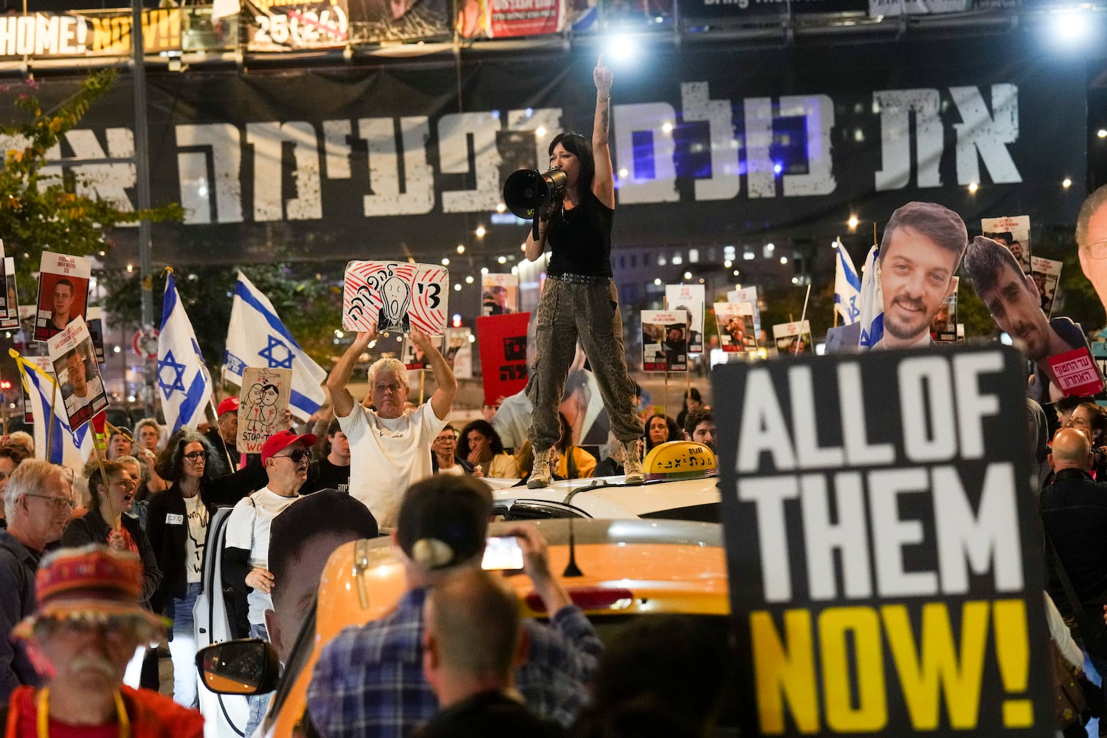 Protesters demand the release of hostages held in the Gaza Strip, in Tel Aviv, Israel, Tuesday, March 18, 2025. (AP Photo/Ariel Schalit)